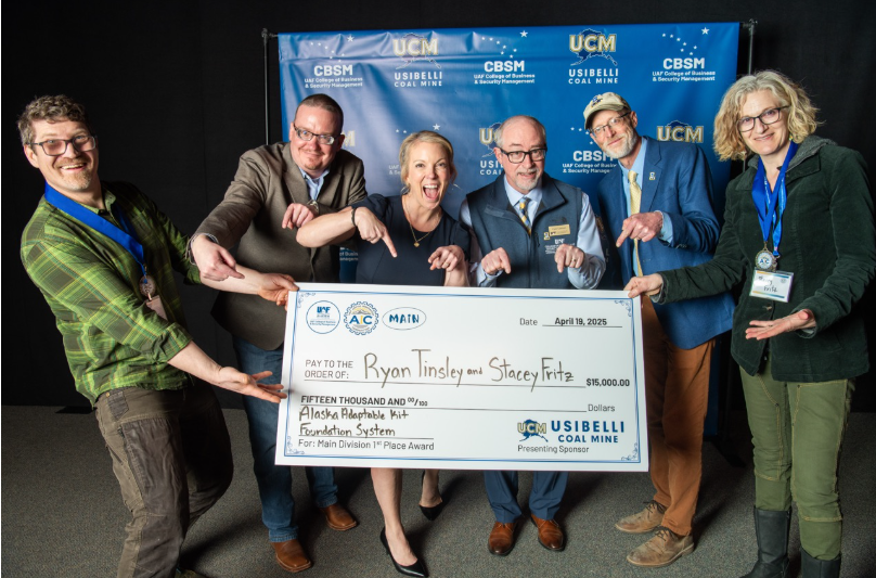 AIC main division champions Ryan Tinsley, left, and Stacey Fritz, right, hold their first-place check. With them are, from left, Justin Seavey of Usibelli Coal Mine; Lisa Cassino Putnam, vice president of public relations for Usibelli Coal Mine; College of Business and Security Management Dean Cameron Carlson; and UAF Chancellor Daniel White.